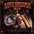 Love smudge kit with rose-adorned sage bundle and rose quartz, arranged for love and heart-opening ritual work.