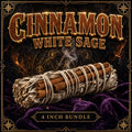 White sage smudge stick wrapped with cinnamon bark sticks, pale green leaves against warm reddish-brown spice.